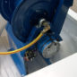 Reel mounts to heavy duty reel lift, which then mounts to bed.  Reel lift makes hose reel access much easier.